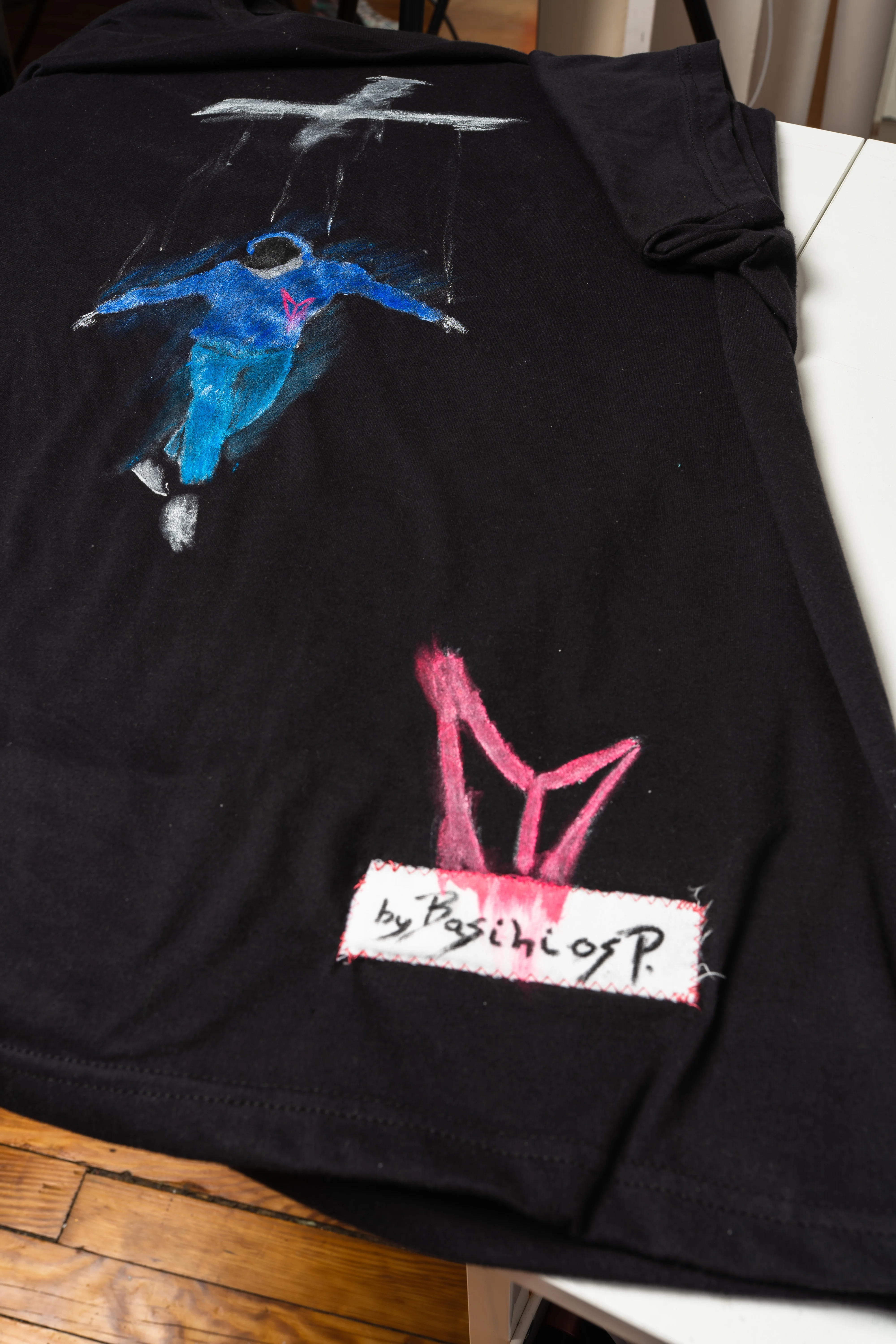 Custom black t-shirt with a blue hand-painted puppet design