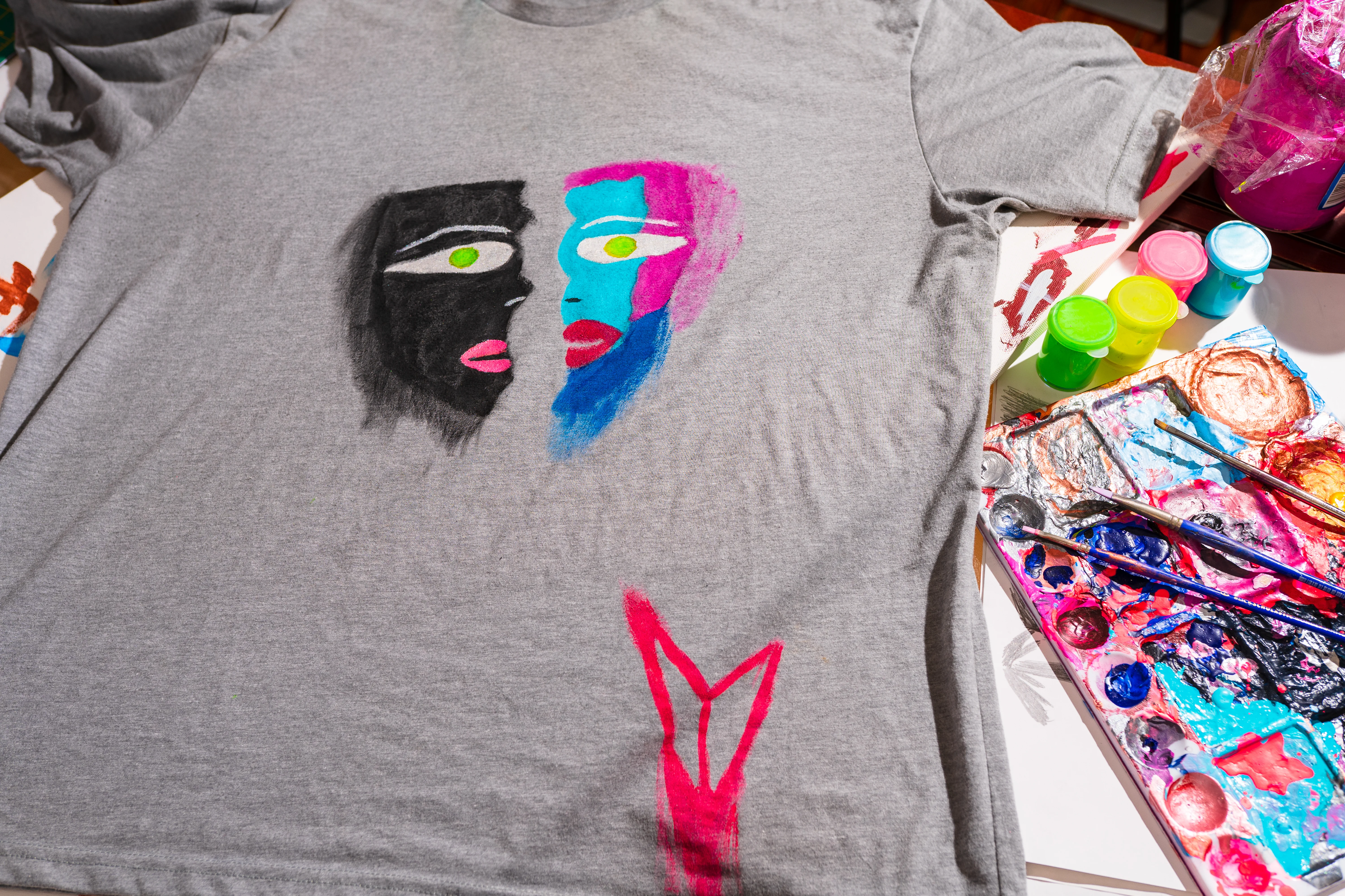 Grey hand-painted dual faces t-shirt behind the scenes in the studio